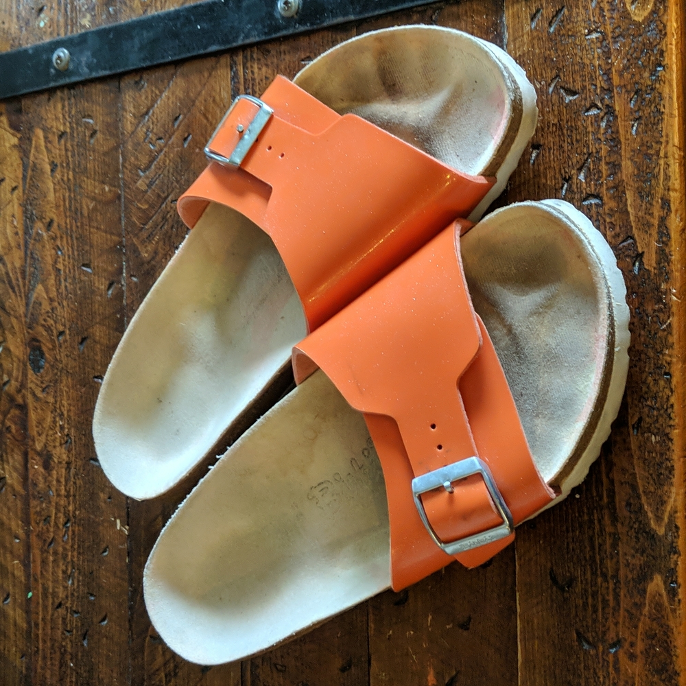 Orange single strap birkis by Birkenstock
